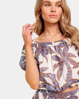 Blue tropical palm print detail on azure blouse