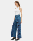 Model wearing Bayeas high rise embroidered wide leg jeans in medium blue with statement floral cutout detailing.