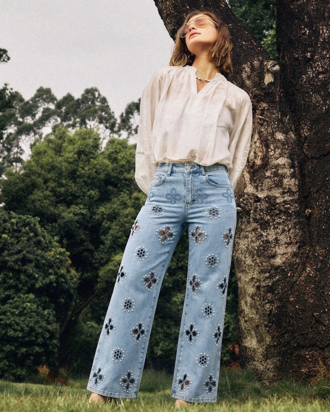 Model wearing BAYEAS high-rise straight-leg jeans with floral cutouts and pearl details