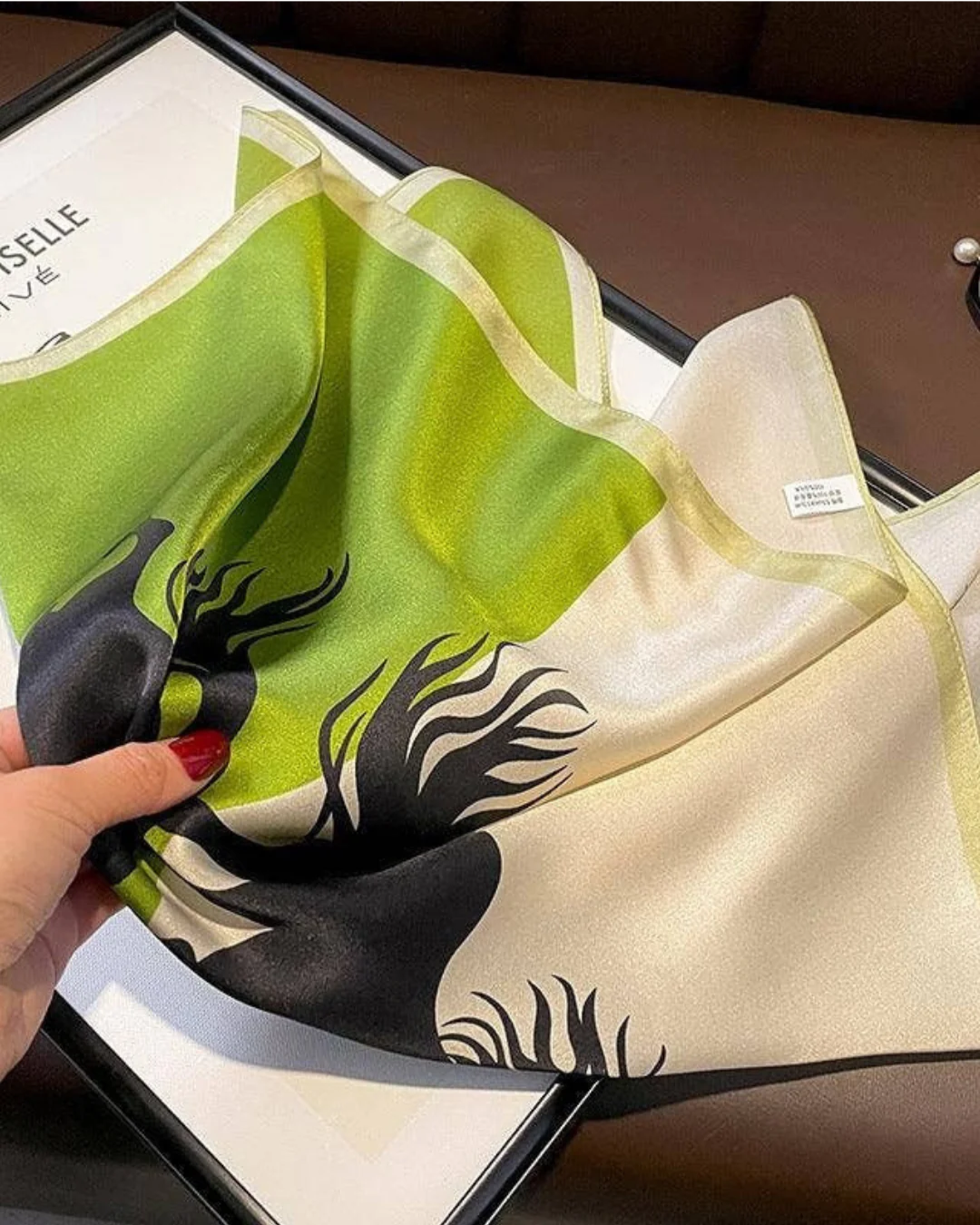 Black stallion mulberry silk scarf flat lay showing equestrian horse design