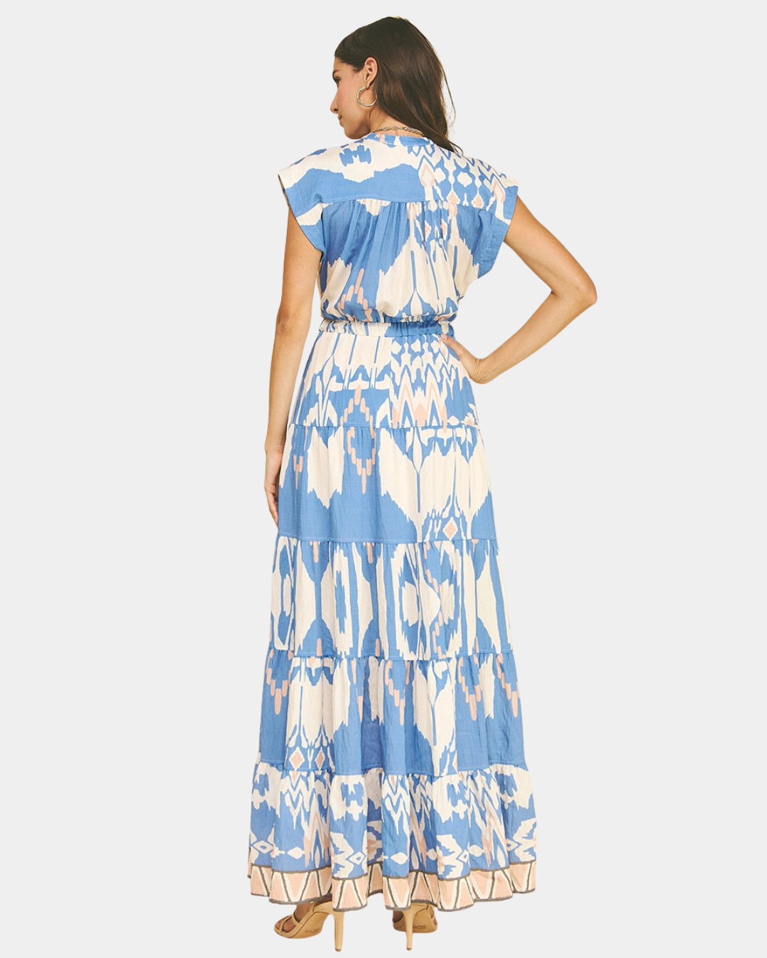 Back view of a blue ikat print maxi dress showing the tiered skirt and adjustable waist.