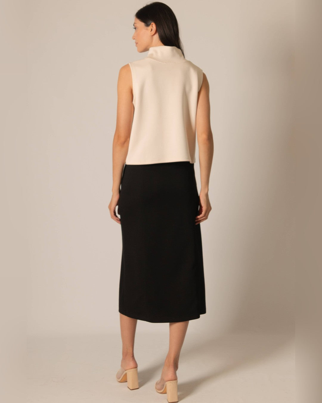 Back view of the black Butter Modal midi skirt with an ivory sleeveless top