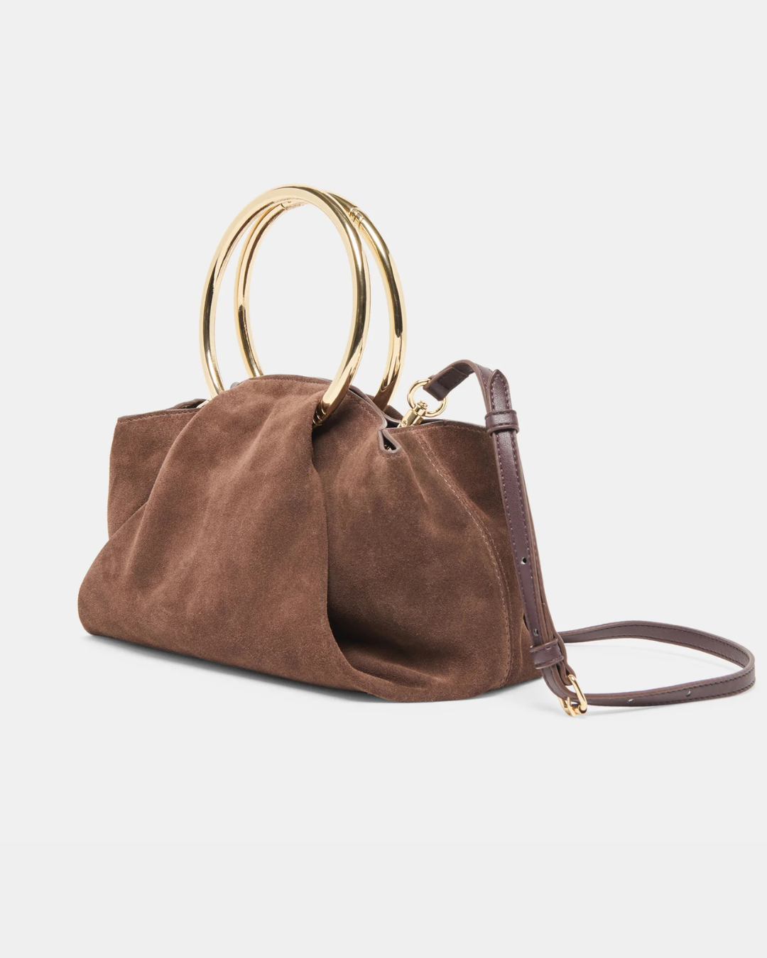 Channing suede bag by Dolce Vita featuring a smooth suede finish and gold O-ring detail.