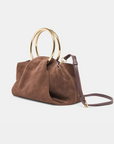 Channing suede bag by Dolce Vita featuring a smooth suede finish and gold O-ring detail.