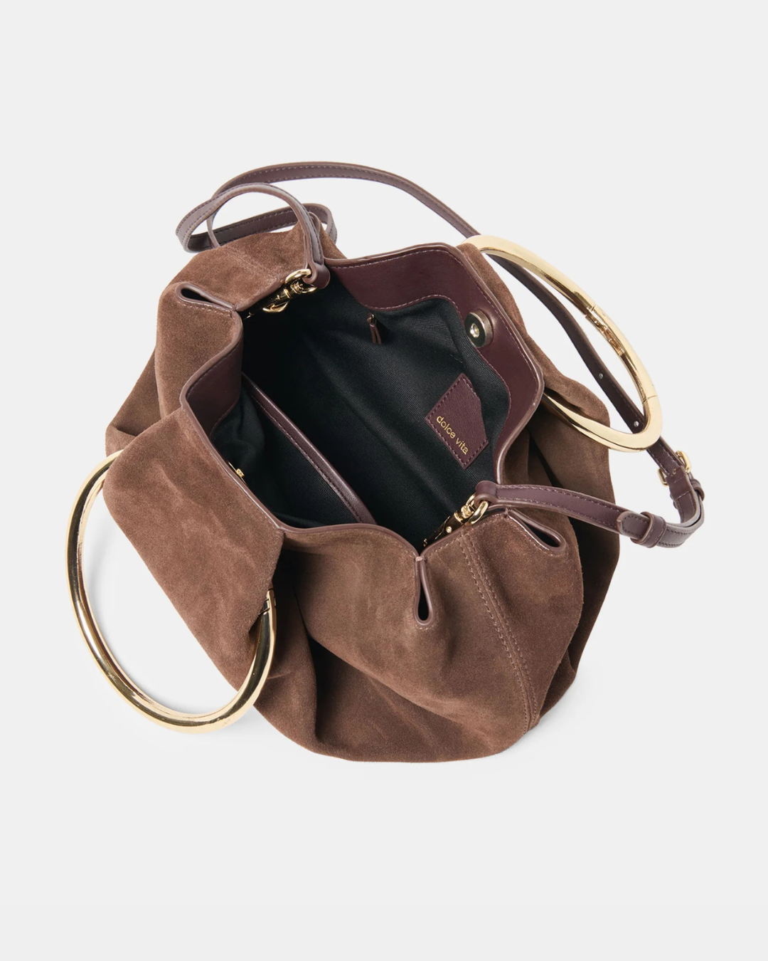 Channing suede bag by Dolce Vita featuring a smooth suede finish and gold O-ring detail.