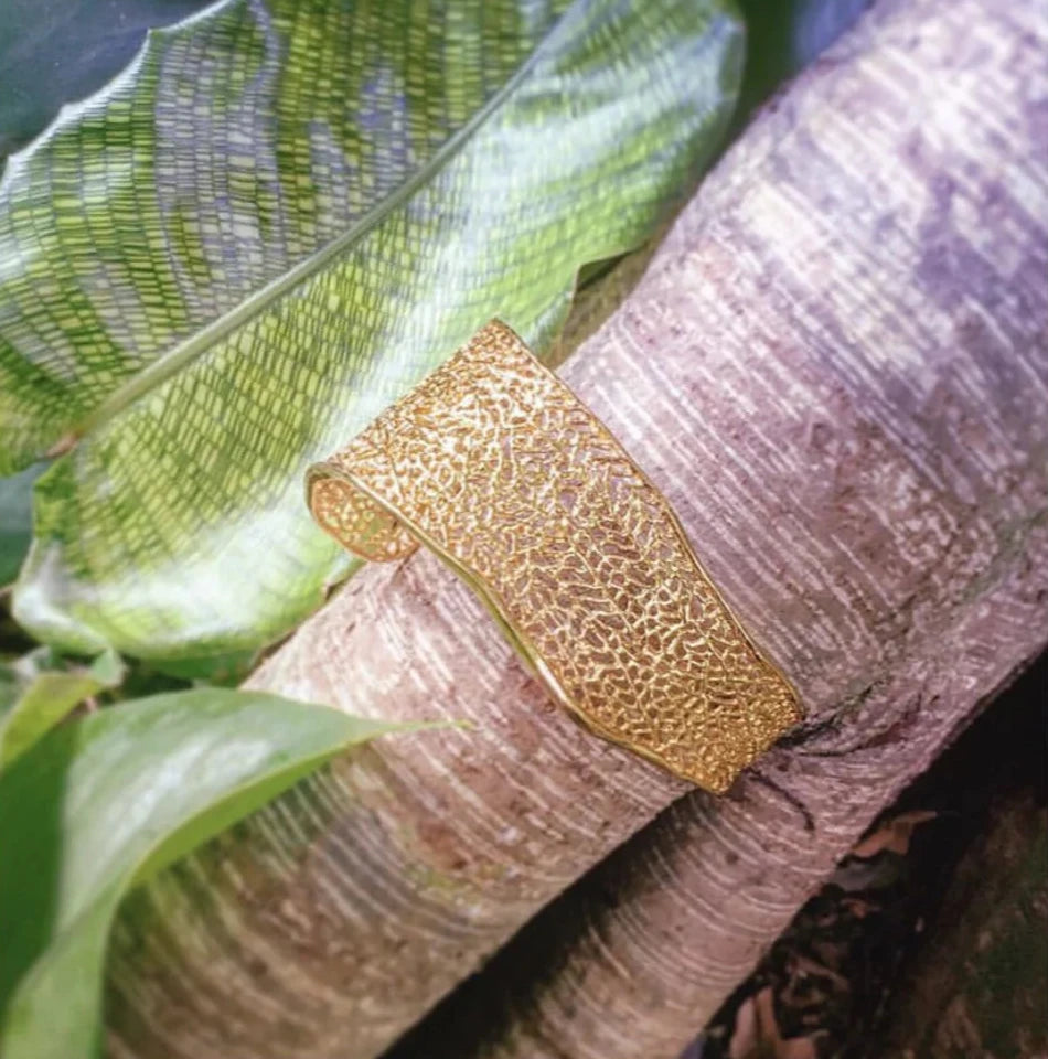 Handcrafted coral cuff bracelet inspired by ocean reef textures in natural surroundings