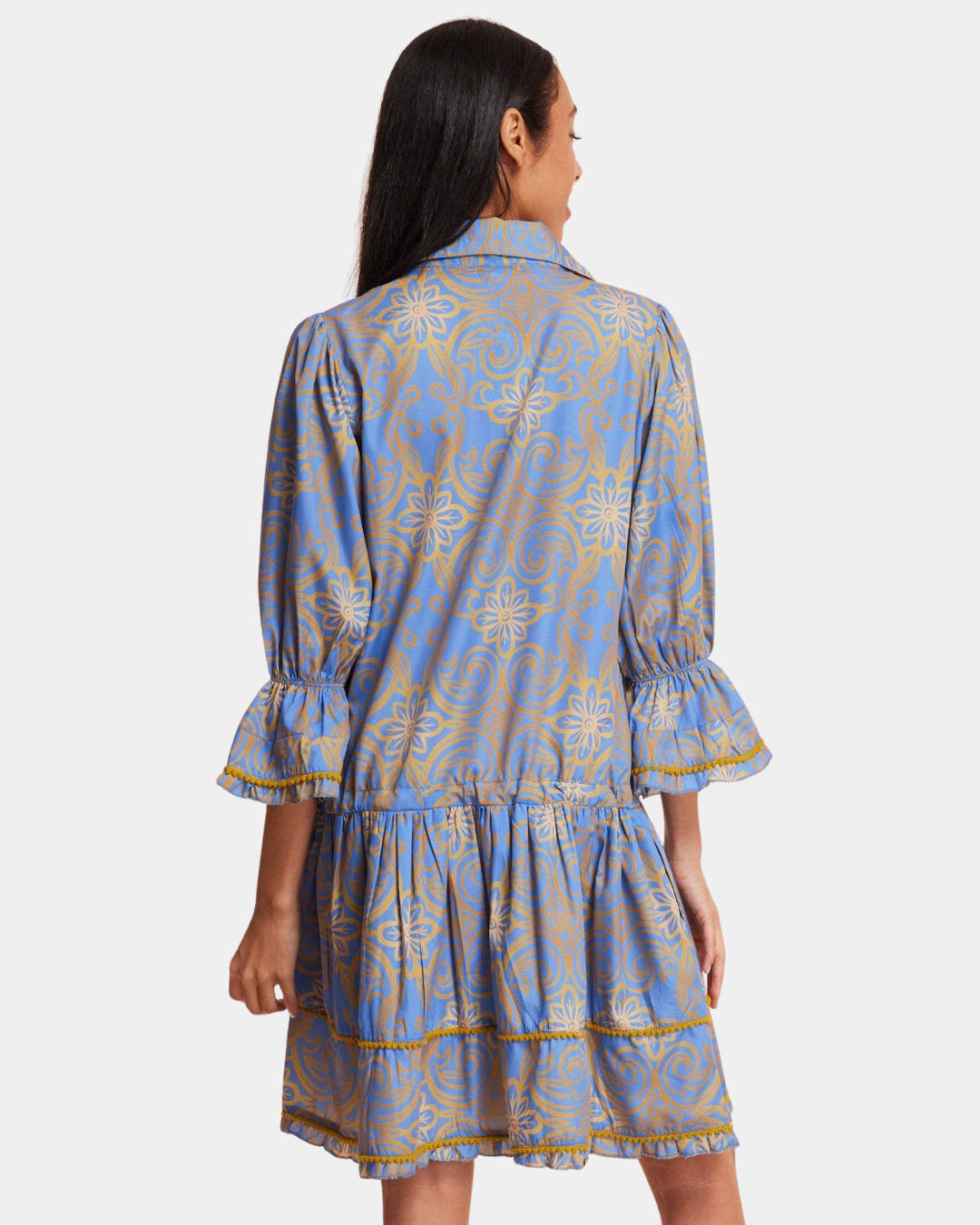 Back view of the Delphine Mini Dress in Blue & Gold showing the floral scroll print and tiered skirt