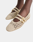 Dolce Vita Baylee women’s ballet flats featuring a woven upper and gold buckle details.