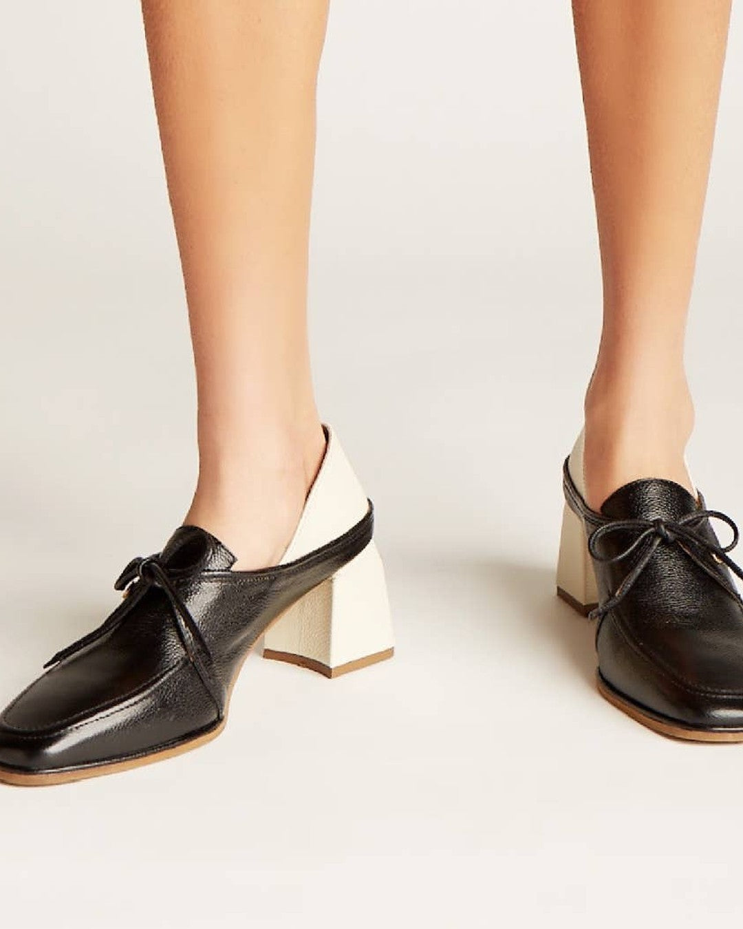 Front three-quarter view of Stivali New York Focus heeled loafers on model