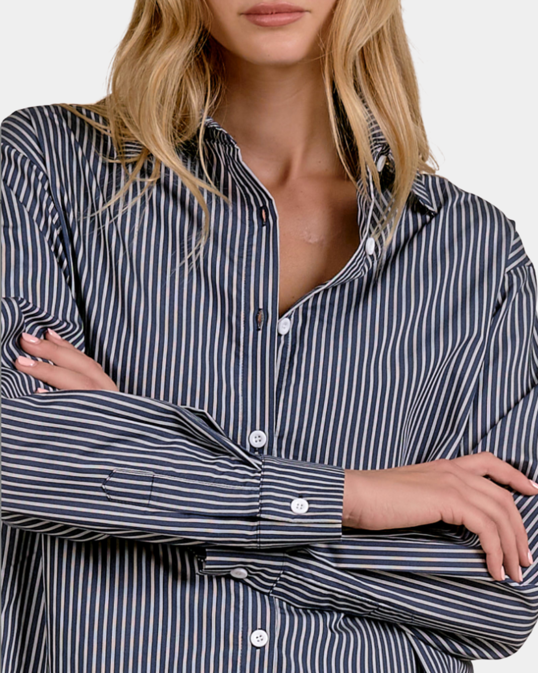 Close-up of the Elan Corey button down shirt in Blue Stripe showing the point collar, buttons and striped fabric.