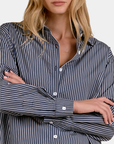 Close-up of the Elan Corey button down shirt in Blue Stripe showing the point collar, buttons and striped fabric.
