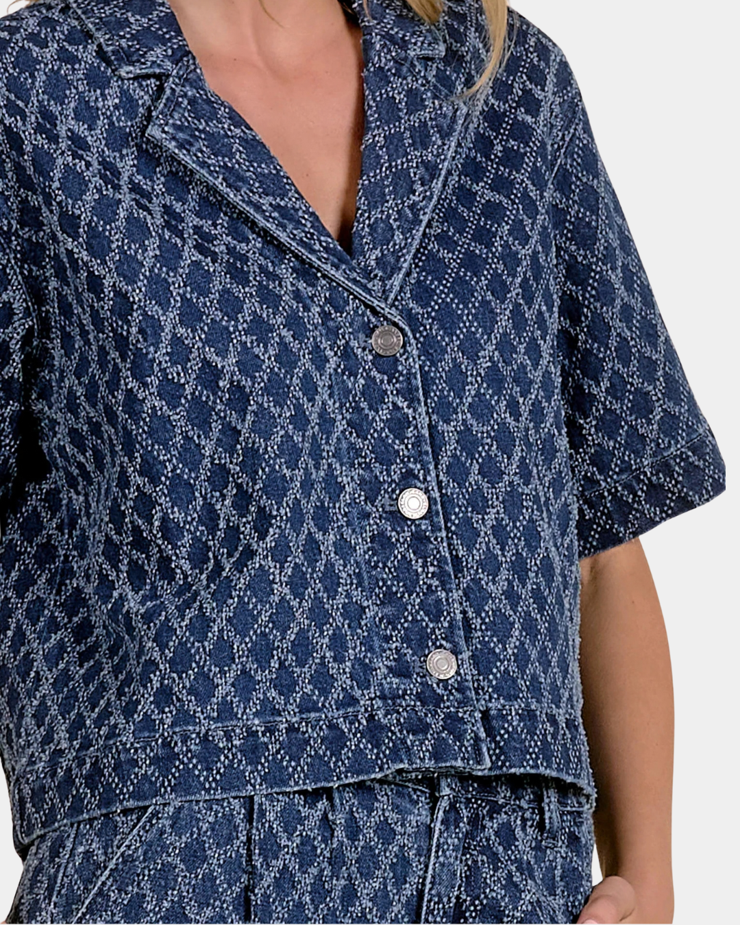 Detail of the Elan Dara Denim Top showing the diamond-pattern denim, wide collar and button front