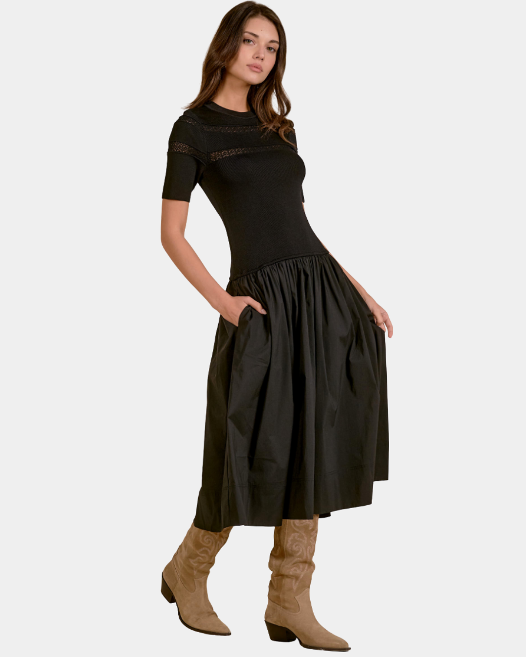 Model wearing the Elan Ember mixed media midi dress in black styled with tall suede boots.