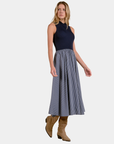 Model wearing the Elan Harlow mixed media midi dress in Blue Stripe styled with suede boots.