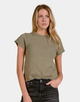 Front view of the Elan Sam Short Sleeve Sweater in Light Olive styled on model