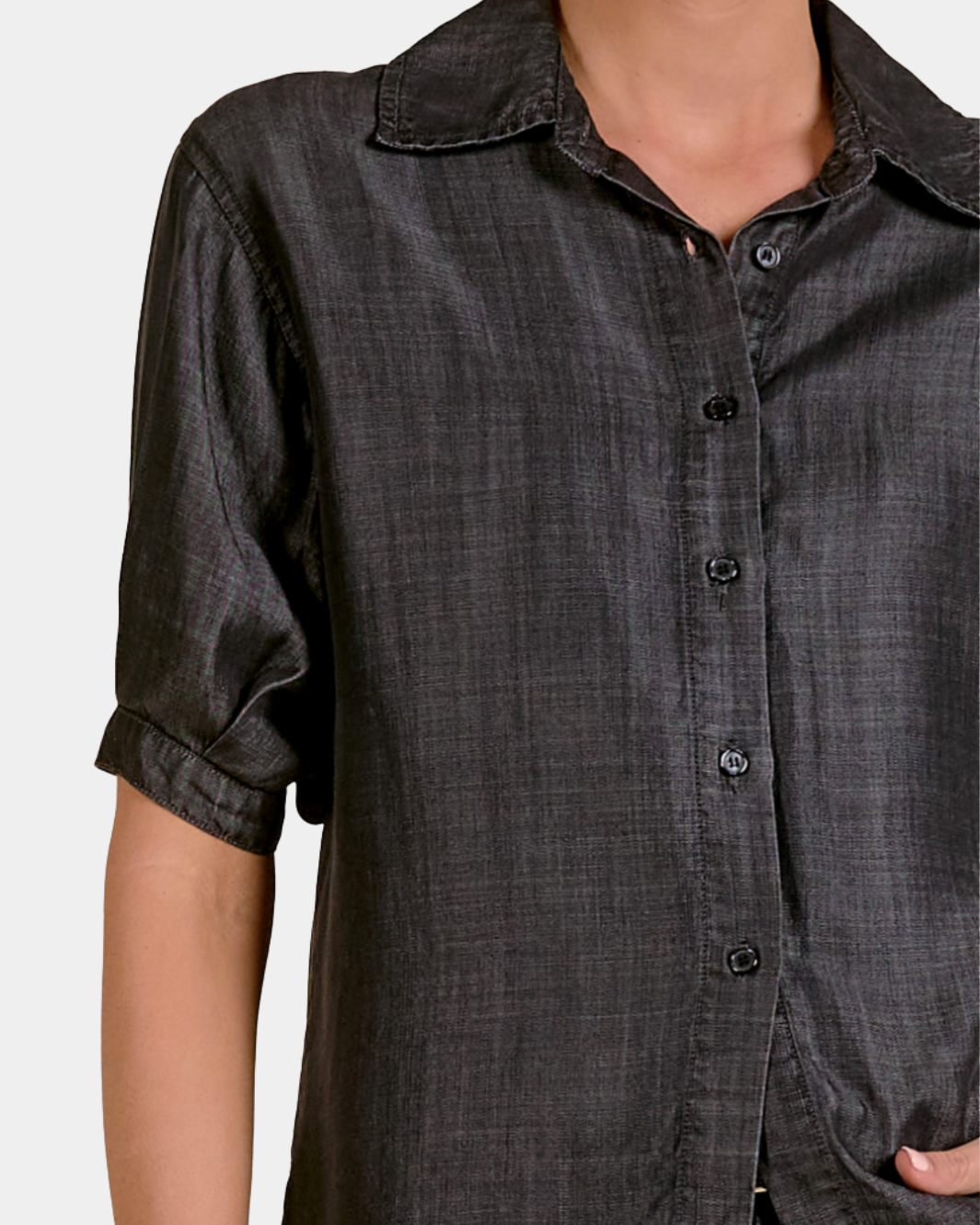 Detail of the Elan Washed Denim Button Down Shirt in Black showing the washed fabric and button front
