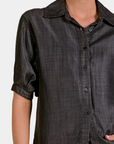 Detail of the Elan Washed Denim Button Down Shirt in Black showing the washed fabric and button front