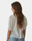 Back view of the Élodie ruffle front blouse with an airy, feminine drape.