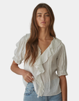 Front view of the Élodie ruffle front blouse featuring soft cascading ruffles and a relaxed silhouette.