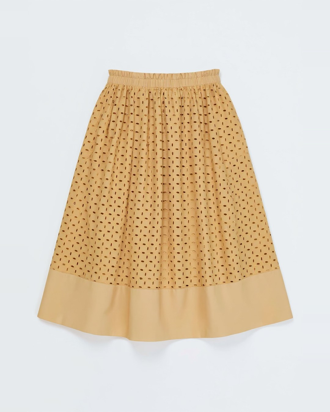Butterscotch eyelet midi skirt laid flat, showing the gathered waist and solid hem band