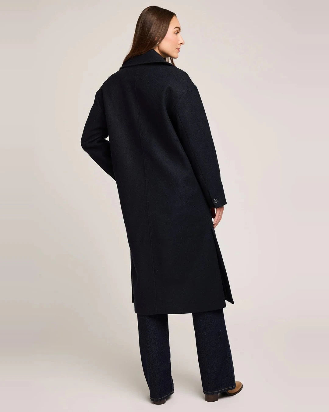 Back view of the long navy Gentle Fawn Agatha Coat with side slit