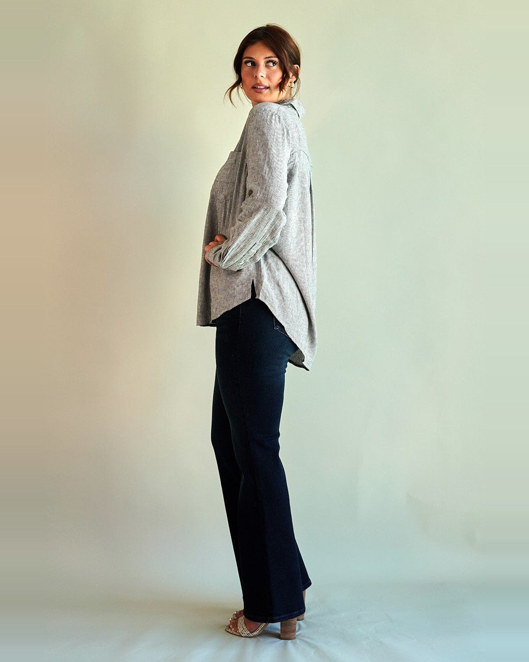 Side view of the Gentle Fawn Arabella striped shirt showing the oversized fit and long curved hem