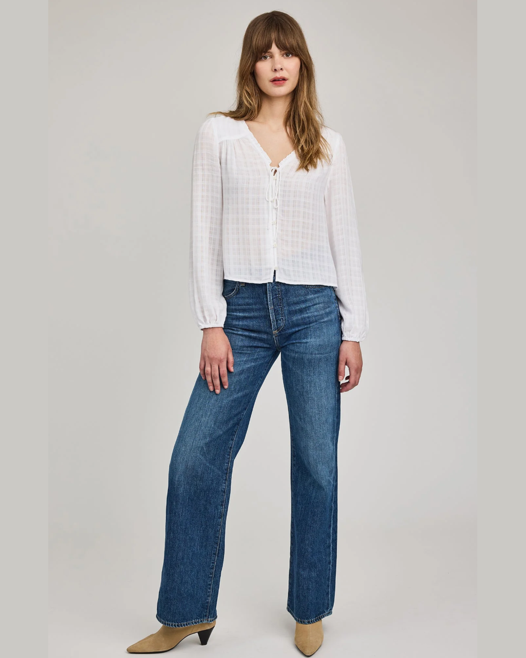 Gentle Fawn Vanessa Blouse in white styled with straight leg jeans and tan pointed-toe heeled boots