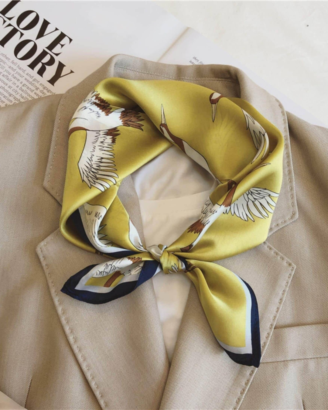 Golden crane mulberry silk scarf styled around the neck