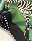 Green zebra print mulberry silk scarf flat lay showing bold animal pattern