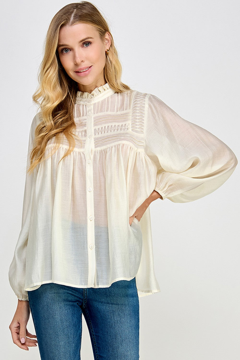 Ivory sheer blouse styled with denim jeans for an elevated casual look
