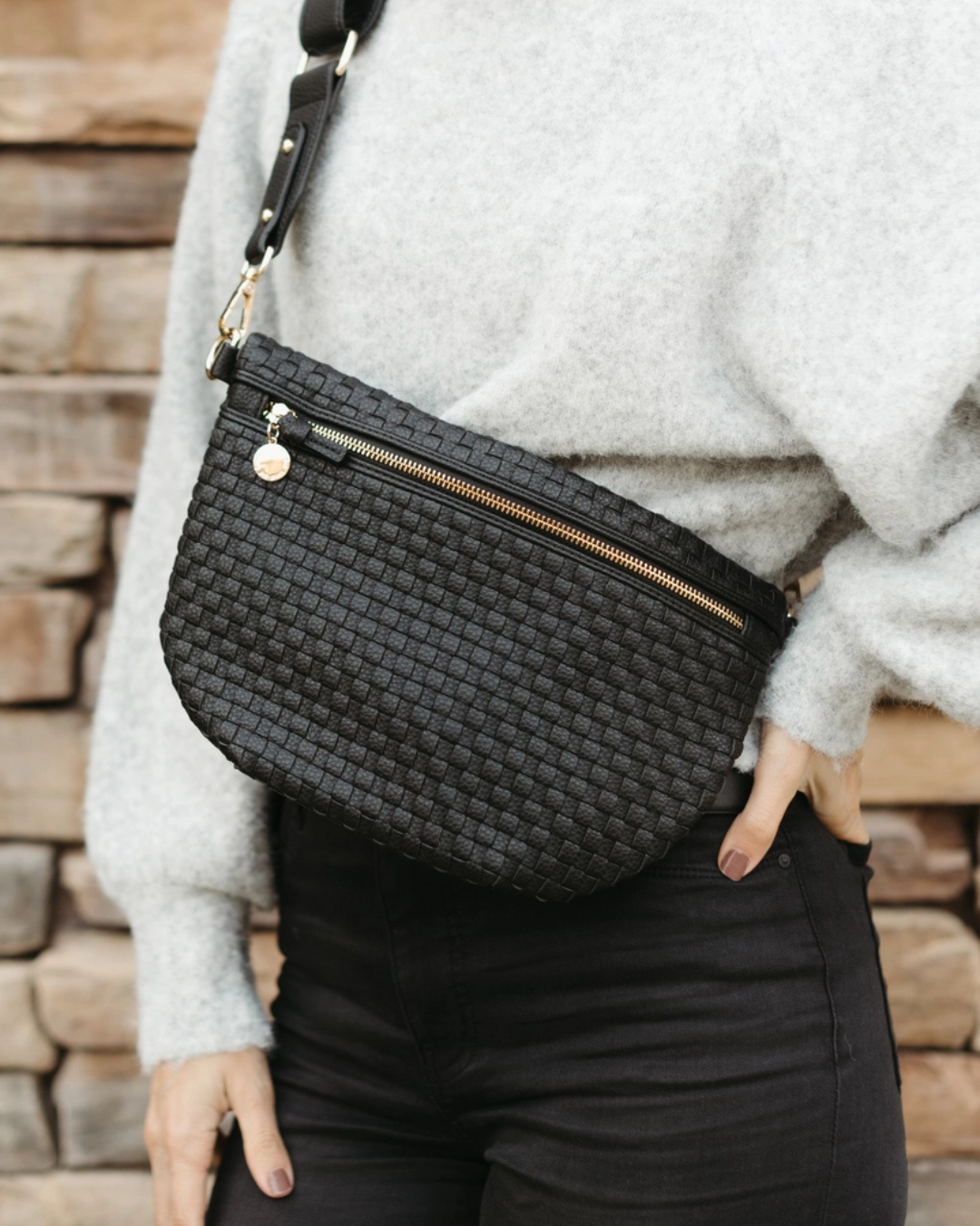 Black woven vegan leather crossbody bag with structured silhouette