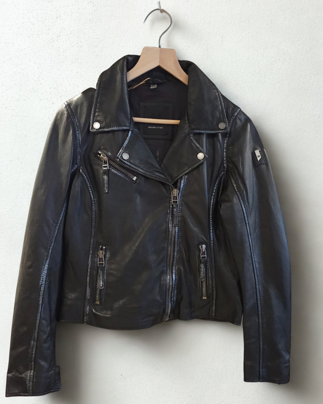 Front view of the Mauritius Christy Black Star Leather Jacket crafted from premium lambskin leather with moto styling, asymmetrical zipper, and subtle distressed seam detailing.