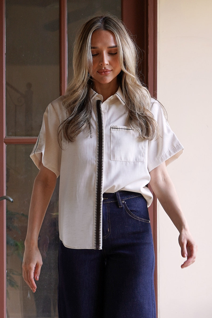 Close-up detail of the Modern Muse Button Down Blouse highlighting the contrast trim, chest pocket, and premium button-front construction.