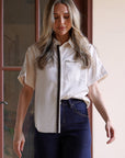 Close-up detail of the Modern Muse Button Down Blouse highlighting the contrast trim, chest pocket, and premium button-front construction.