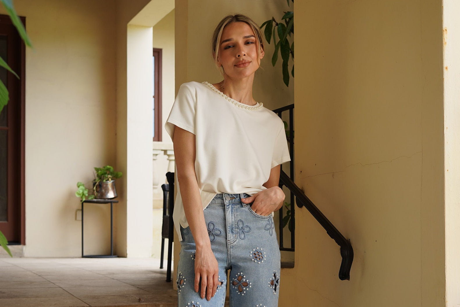 Monaco Pearl Trim Tee in ivory featuring an elegant pearl-trim neckline and relaxed short sleeve silhouette.