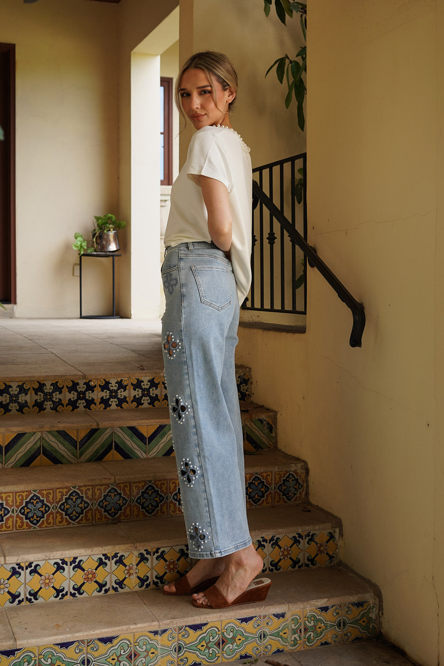 Side view of the Monaco Pearl Trim Tee in ivory with pearl neckline detailing and soft knit fabric.