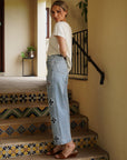 Side view of the Monaco Pearl Trim Tee in ivory with pearl neckline detailing and soft knit fabric.