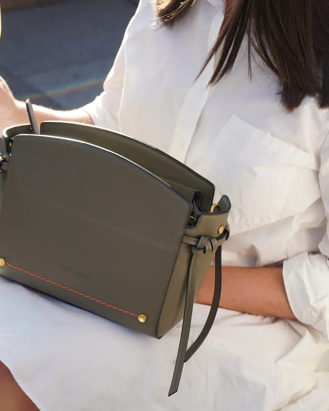 Montemare Roma Crossbody Bag in olive styled with a white outfit