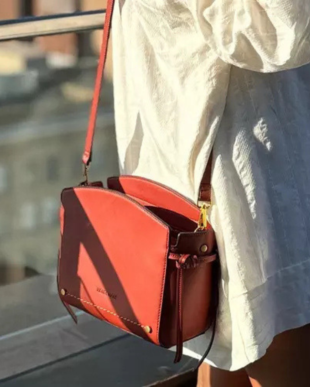 Montemare Roma Crossbody Bag in terracotta worn crossbody with a white dress