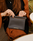Montemare Roma Square Pouch in Slate shown in a lifestyle setting.