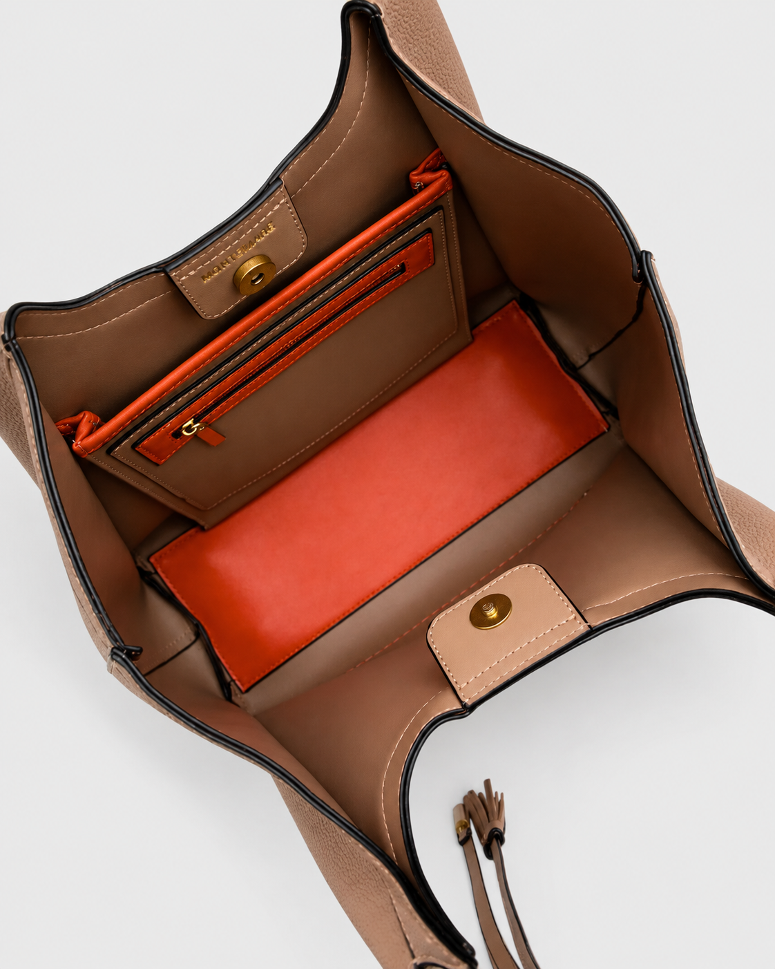 Interior view of the Montemare Sedona Tote in Latte showing the spacious interior, zip pocket, magnetic closure and contrasting orange accents.