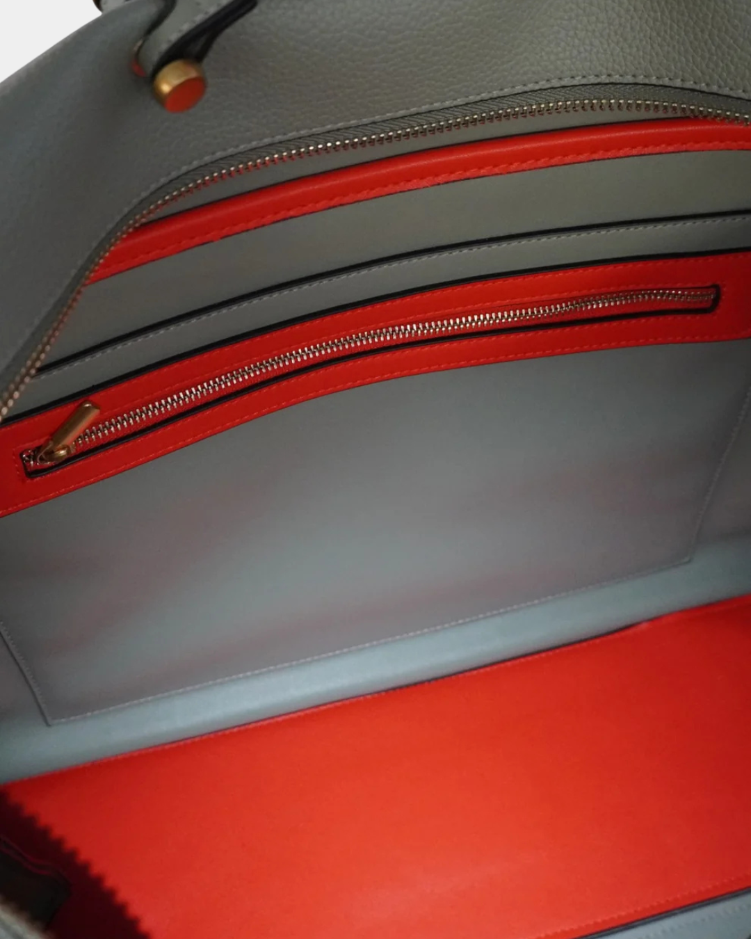 Interior of Montemare Vienna Carry-On in Blake’s Blue showing red contrast lining, zippered pocket and interior compartment