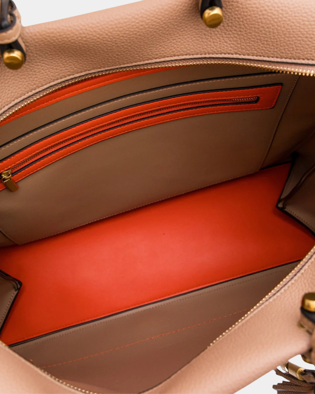 Interior of Montemare Vienna Carry-On in Latte showing orange contrast lining and zippered interior pocket