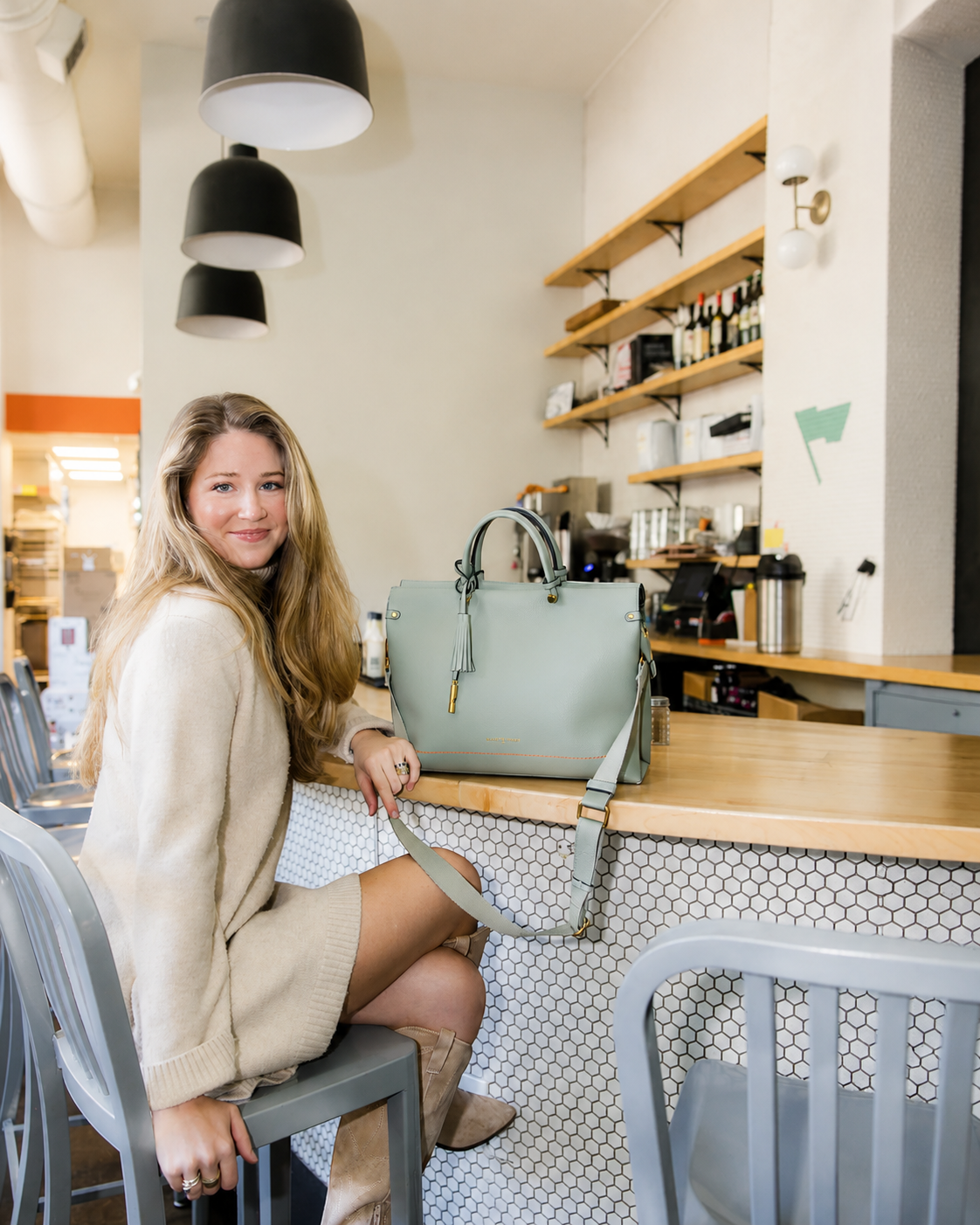 Montemare Vienna Small Carry On Tote in Blakes Blue styled in a cafe lifestyle setting