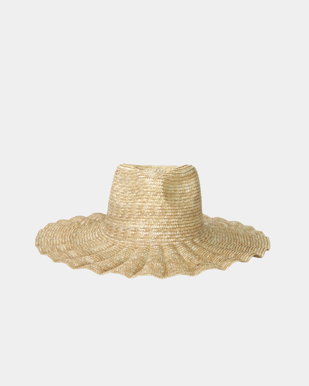 The Nalu wide brim straw hat in natural features a rancher crown and softly wavy brim for effortless summer sun protection.