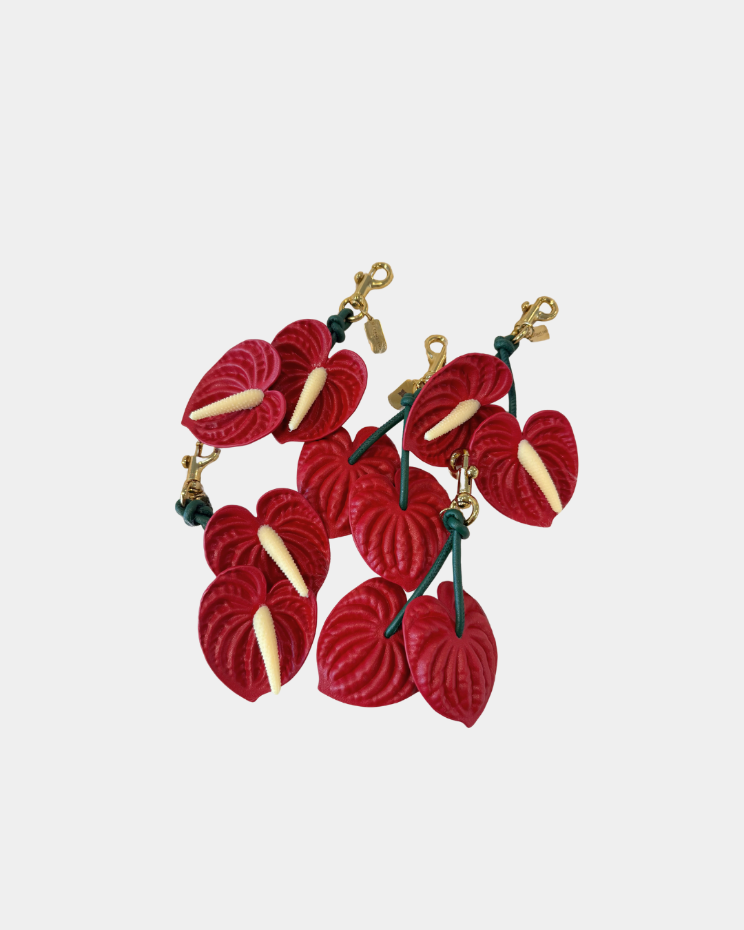 Oceans End red anthurium bag charms grouped together showing floral design and texture