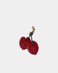 Close-up of Oceans End anthurium bag charm showing textured red floral detail