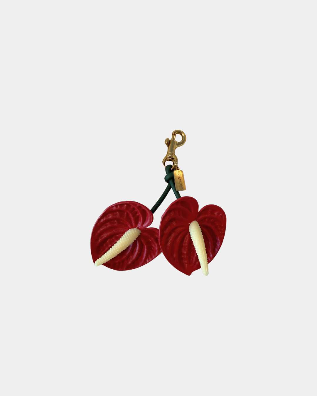 Oceans End anthurium bag charm in red with gold clasp and green stem detail