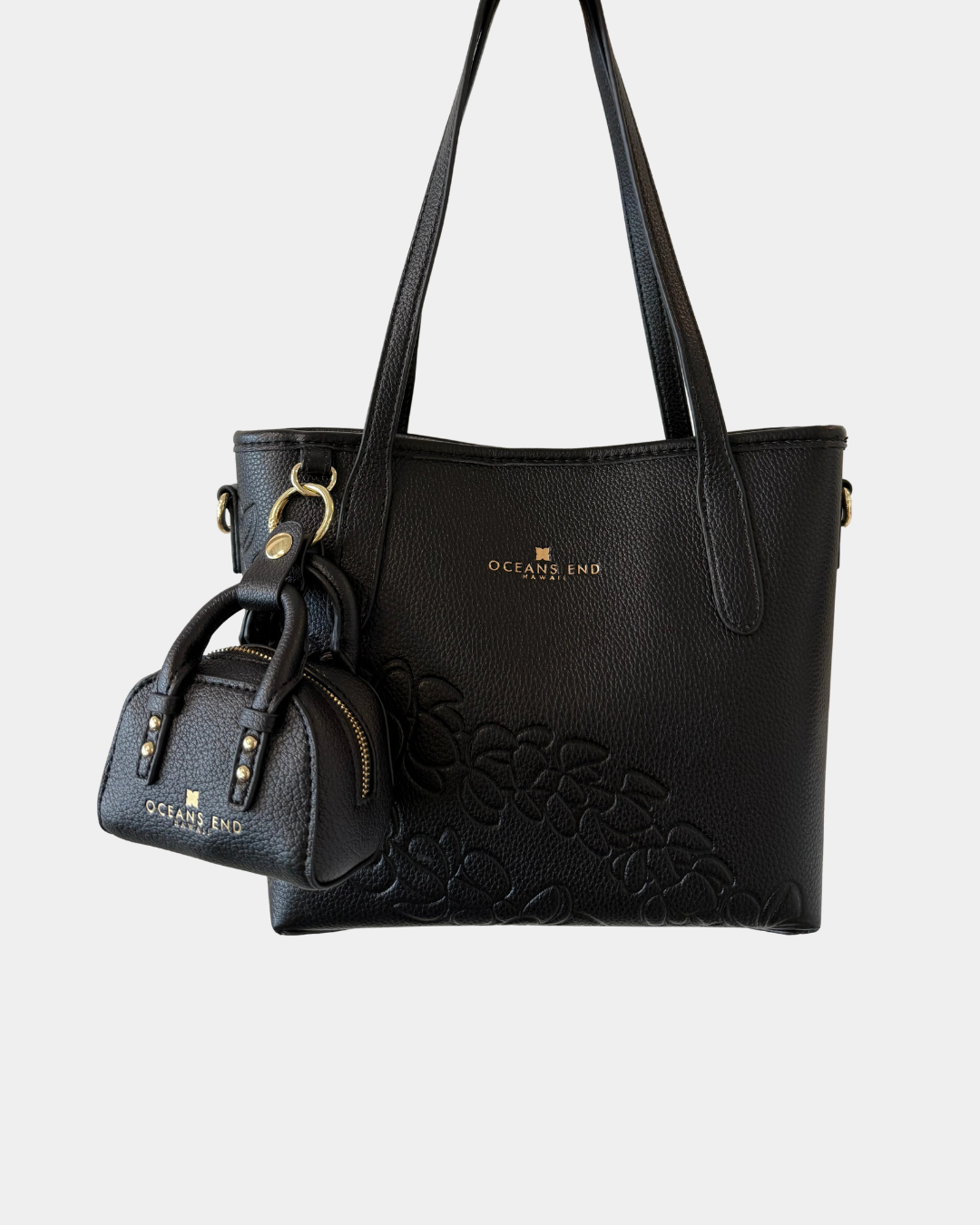 Oceans End mini handbag charm in onyx attached to handbag as a purse accessory