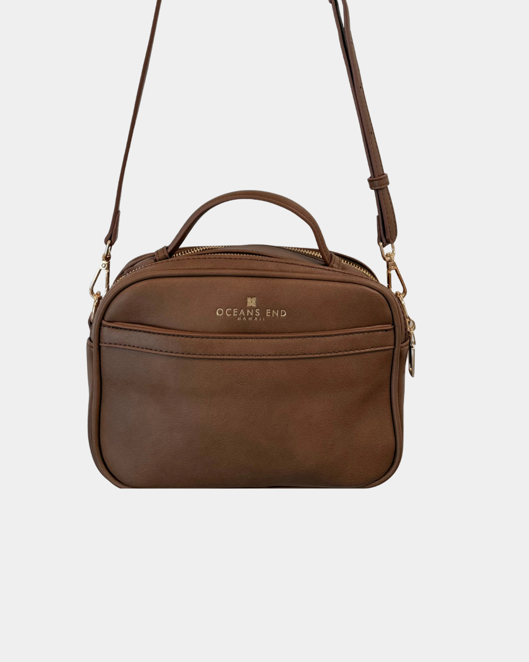 Back view of the Oceans End Justine 2.0 mocha crossbody bag featuring a convenient exterior slip pocket, top handle, and adjustable shoulder strap.